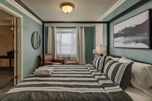 a bedroom with a large bed and a window at Downtown Condo Epic Views in Anchorage