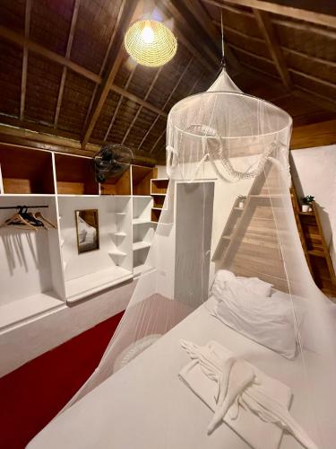 a room with a bed with a skeleton on it at Zhaya's Beachfront in El Nido