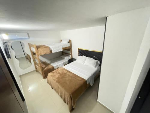 a small room with two bunk beds in it at ARY Hotel in Valledupar