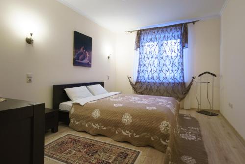 a bedroom with a bed and a window at PaulMarie Apartments on Chehova in Mogilev