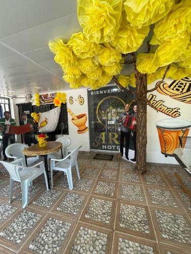 a dining room with a table and chairs at ARY Hotel in Valledupar