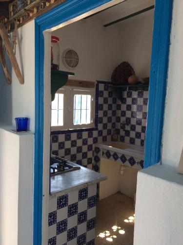 a kitchen with a counter and a stove top oven at El Baraka in Houmt Souk