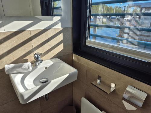 a bathroom with a sink and a window at Floating Comfort in Peenemünde in Peenemünde