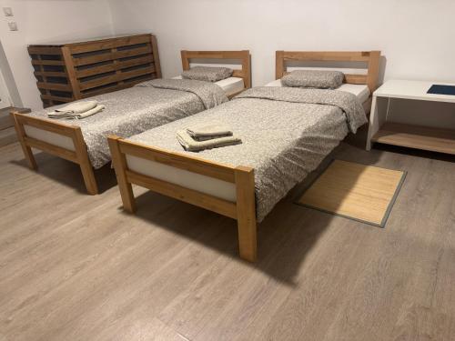 a room with two beds and a table at Studio Maša in Zaječar