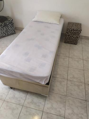 a bed sitting on top of a tiled floor at Conexão SP in São Paulo