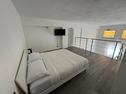 a bedroom with a bed and a flat screen tv at Le Cinque Terre da Pippo in La Spezia