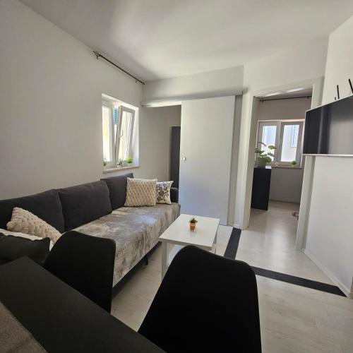 a living room with a couch and a table at Apartma Sparkle in Koper