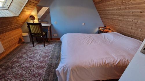 a bedroom with a bed and a desk with a chair at Pen An Lan in Pleumeur-Bodou