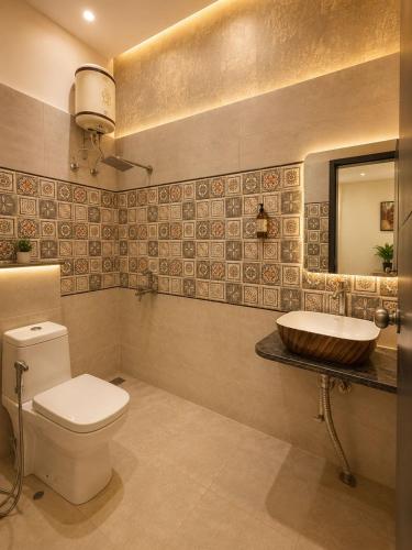 a bathroom with a toilet and a sink at Hotel Crystal Blues in Mathura