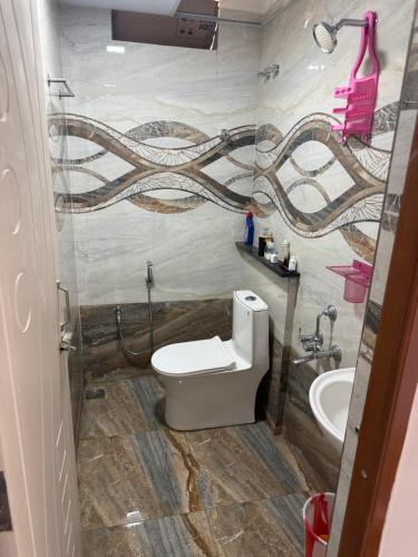 a bathroom with a toilet and a sink at DRK Luxury Stays in Siruseri