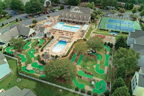 an aerial view of a resort with a pool and tennis courts at Kingsgate Resort 2BR Apartment in Williamsburg