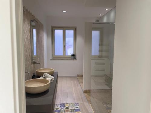 a bathroom with a large tub and a sink at Maison Mabette in Farigliano