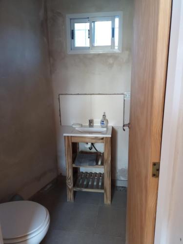 a bathroom with a sink and a toilet at El último Cartucho in Tandil