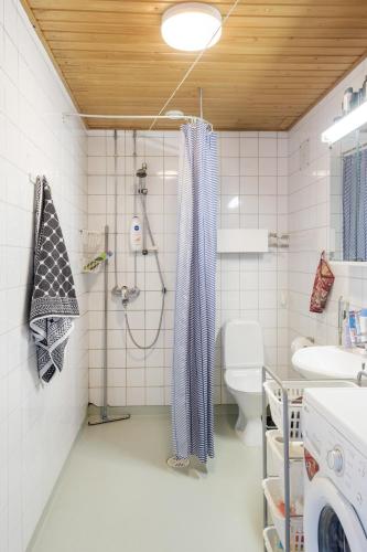 a bathroom with a shower and a toilet at Peace & Harmony in Espoo