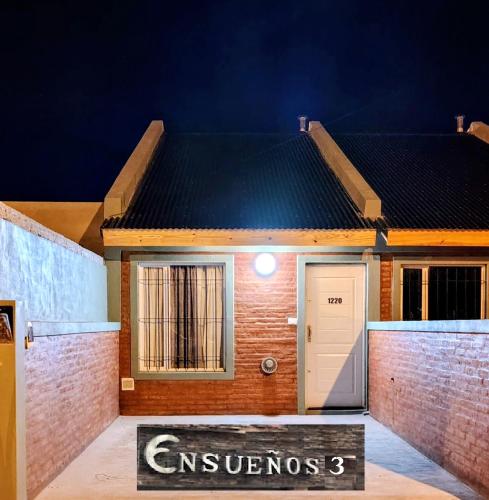 a house with a sign in front of it at Departamentos Ensueños in Trelew