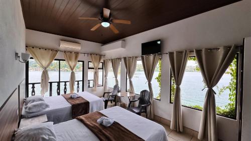 a hotel room with two beds and a large window at La Posada De Don Jose in Flores