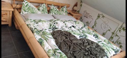 a bed with a blanket and pillows on it at Ferienwohnung Anke Günther Dach in Bad Kissingen