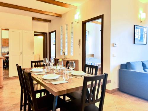 a dining room with a wooden table with wine glasses at Chalet San Primo in Castiglione dʼIntelvi