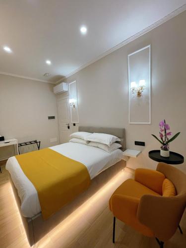 a bedroom with a large bed and a chair at Ciao Termini in Rome