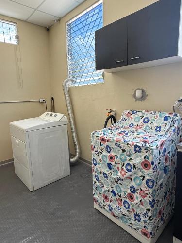 a hospital room with a chair and a window at Room #2 donde Alice in San Miguel