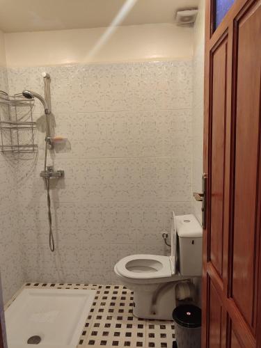 a bathroom with a toilet and a shower at Ryad dar midelt in Midelt