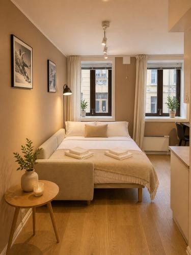 a bedroom with a large bed and a table at 70 Degrees North City Apartments in Tromsø