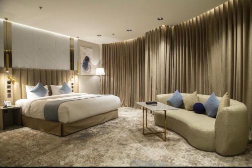 a hotel room with a bed and a couch at فندق راسيا in Medina