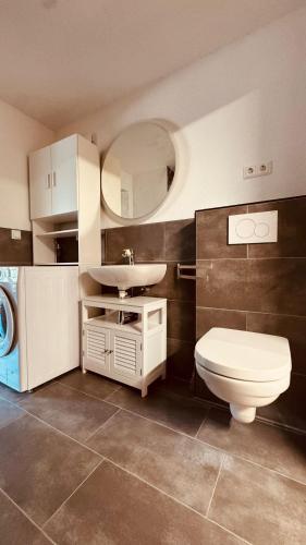 a bathroom with a toilet and a sink and a mirror at Cozy & small apartment-Böblingen in Böblingen