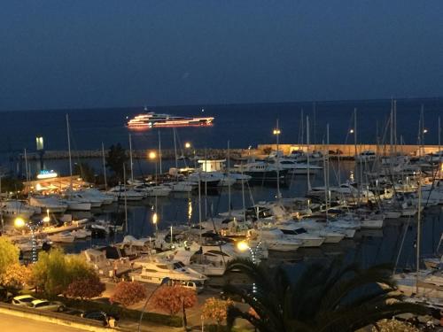 a group of boats docked in a marina at night at ibis budget Menton Bord de Mer in Menton