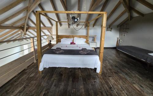 a bedroom with a large bed in a attic at Splendide villa de Courcelles 4 étoiles Piscine & jacuzzi in Saint-François
