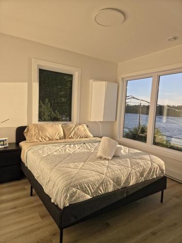 a bedroom with a bed with two large windows at The View in French Village