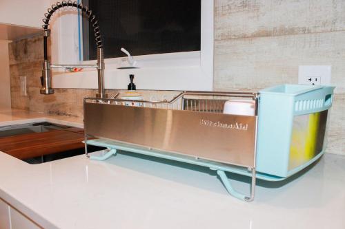 a kitchen sink with a dish drying rack on the counter at The View in French Village