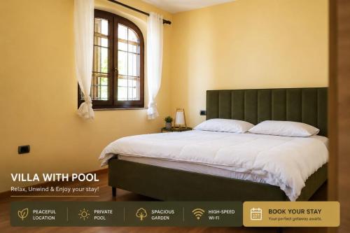 a bedroom with a bed with a green headboard and a window at Villa Pool & Sun Durrës in Durrës