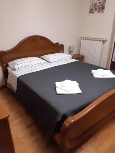 a bedroom with a bed with two white towels on it at Casa Marina in Omegna