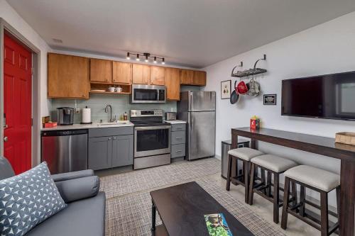 a kitchen with stainless steel appliances and a living room at 2 Mins from Airport 1 BDR with Large Backyard in Anchorage