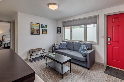 a living room with a couch and a red door at 2 Mins from Airport 1 BDR with Large Backyard in Anchorage