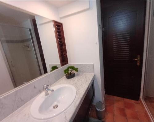 a bathroom with a sink and a mirror at Studio vue sur la mer, piscine - L'Oasis de Tartane in La Trinité
