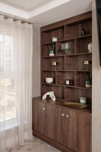 a large wooden cabinet in a room with a window at Castlecroft House with Hot Tub in Dungiven