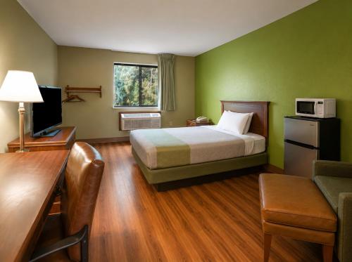 a hotel room with a bed and a desk and a television at Motel 6 Morehead, KY in Morehead