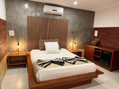 a bedroom with a bed and a television in it at Pousada Oasis Paracuru in Paracuru