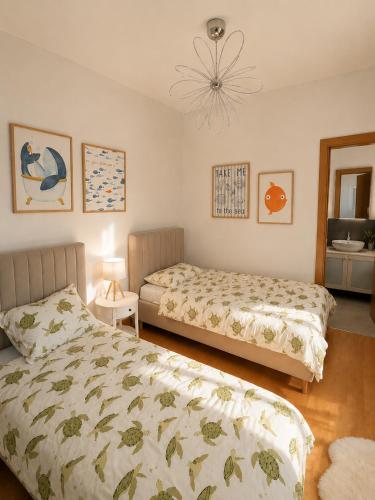 a bedroom with two beds and a chandelier at Villa Igalo Splitska - Private Pool & Sea View in Splitska