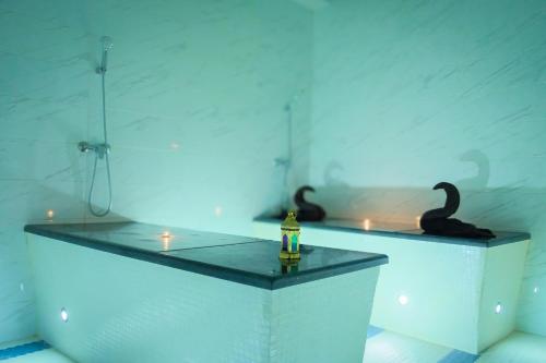 a room with two black swans on a table with candles at HAMILTON Agadir in Agadir