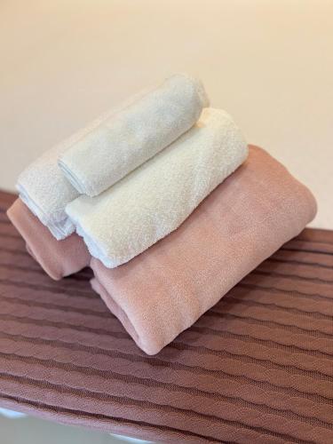 three towels sitting on top of a table at Flat no Centro da Cidade in Parauapebas