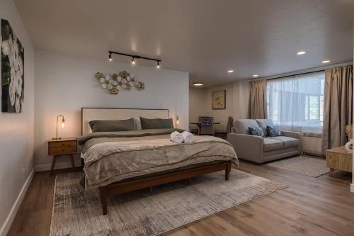 a bedroom with a large bed and a couch at Modern Downtown Studio - King Bed - Inlet Views in Anchorage
