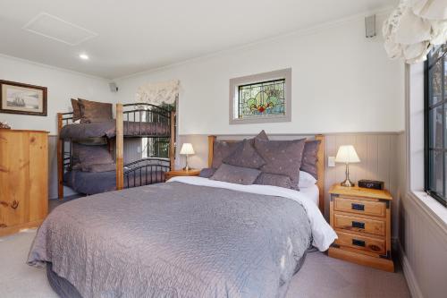 a bedroom with a bed and a bunk bed at Private seaside couples hideaway in Kaka Point