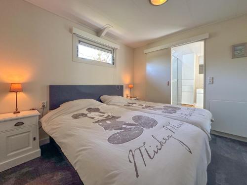 a bedroom with a bed with a sign on it at Zout en Peper in Kattendijke