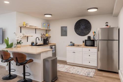 a kitchen with a stainless steel refrigerator and a counter at Stylish Downtown Studio - Free Parking plus Kitchen in Anchorage