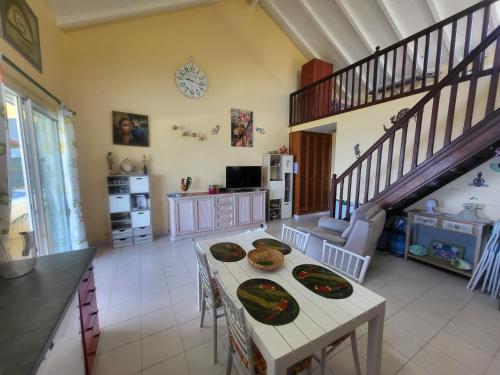 a kitchen with a table with two plates on it at KAZ A CE TI MOUN LA, à Deshaies in Deshaies