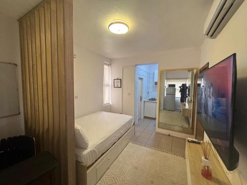 a bedroom with a bed and a large mirror at Exquisite 1-bed studio apartment in Ikoyi in Lagos