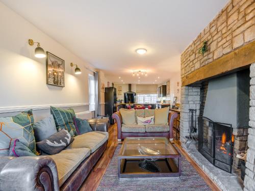 a living room with couches and a fireplace at Cromwell House - Uk42450 in Winforton
